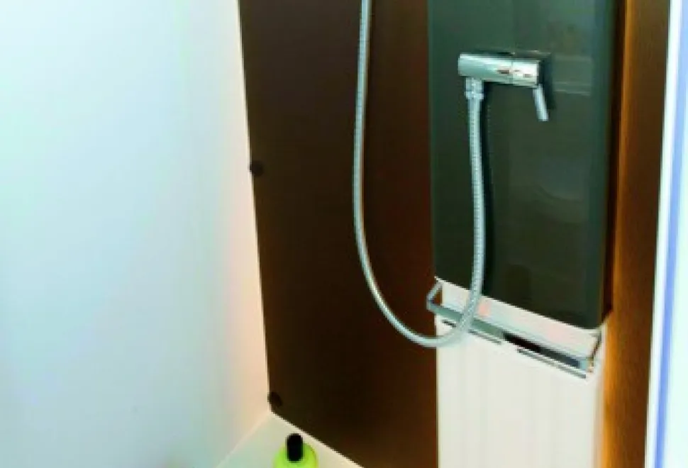 A-panel-radiator-in-the-shiwer-cubicle-and-a-rail-above-it-for-towels-to-dry-efficiently-65344