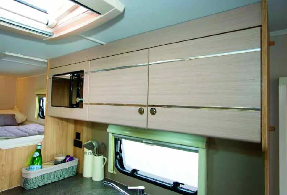 The-top-locker-design-is-stunning,-with-the-mirrored-microwave-set-flush-into-the-pale-matt-finish-woodwork--01222