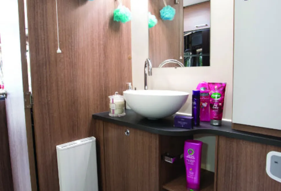 The-washbasin-has-a-rise-and-fall-plug;-the-cabinet-beneath-contains-a-linen-bag-w500-42852