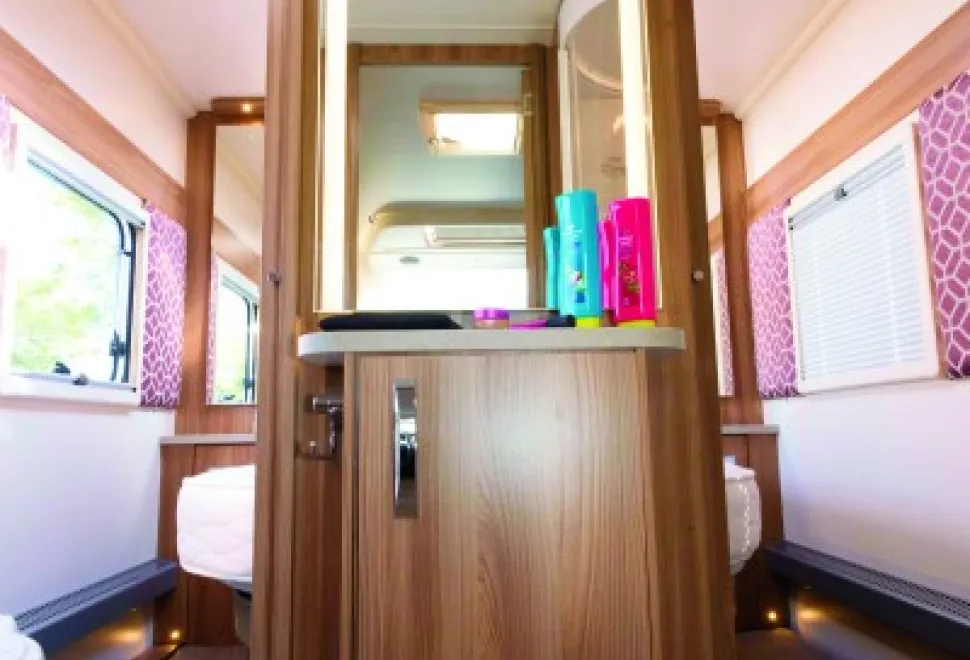 In-the-centre-of-the-preening-room,-a-dressing-table-with-a-backlit-mirror-43846
