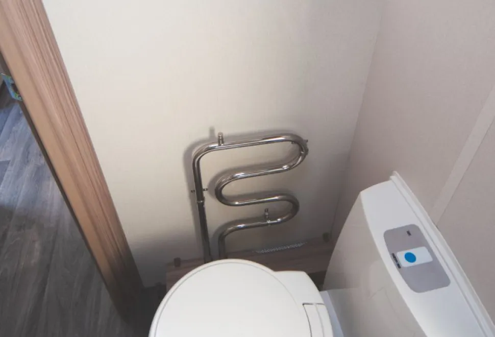 A-heated-towel-rail,-part-of-the-Alde-heating-system,-sits-on-the-forward-wall-of-the-washroom-24642