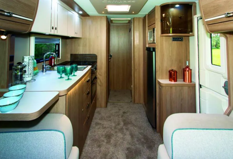 At-the-ed-of-the-kitchen-two-doors,-one-hinged,-the-other-sliding,-section-off-the-washing-facilities-41744
