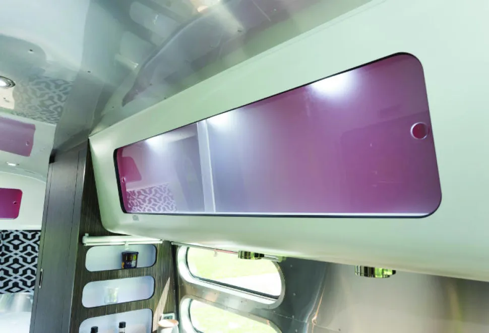 Frosted-sliding-doors-on-all-cabinets,-and-red-interiors,-are-all-part-of-the-Airstream-style-w800-71236