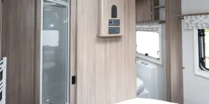 A TV bracket and connections are on the wall at the foot of the bed