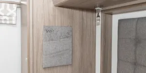 Fabric pockets that are ideal for phones are on each side of the bed 