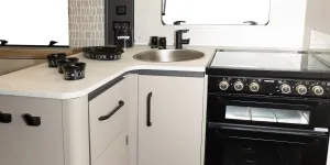 The L-shape gives the kitchen a slightly enclosed feel, almost like a separate room