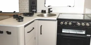 The L-shape gives the kitchen a slightly enclosed feel, almost like a separate room