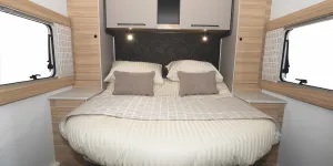 Large cabinets are on each side of the bed