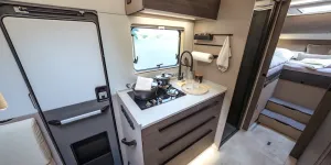 Interior view showing door (no window), kitchen , shower and single beds at the back: Frankia Noctra Cruiser 7.6L