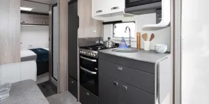 An open kitchen leading towards the rear bedroom