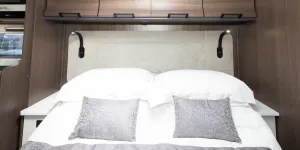 The over-bed lockers are a reverse-curve shape