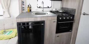 A large sink and a three-burner hob