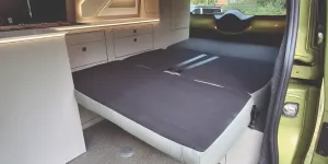 The bed inside the Hillside Birchover Classic T7 campervan