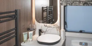 Black fittings and a backlit mirror