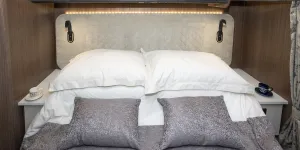 A row of LED bulbs outlines the top of the bedhead