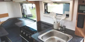 A-three-burner-hob,-combined-oven-grill-and-a-surface-extension-to-hinge-up-at-the-rear-16898