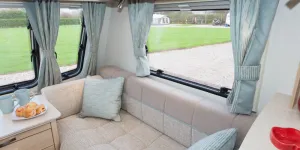 web-The-unique-Osprey-fabric-scheme-features-cushions-and-curtains-with-a-subtle,-light-reflecting-pattern-12759