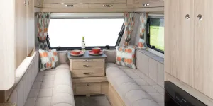 Bright-mango-orange-in-curtains-and-cushions,-teamed-with-pale-woodwork,-creates-a-light-and-airy-look-w800-87191