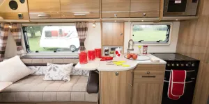 The-kitchen-surface-is-almost-L-shaped,-jutting-forward-over-the-dual-purpose-unit-beneath-83857