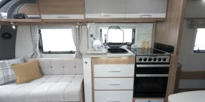 Kitchen-styling-is-ultra-modern,-with-white-and-grey-doors-and-a-splashback-with-a-subtle-geometric-design-w800-88027