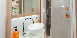 Lighting-runs-beneath-the-mirror,-illuminating-the-splash-back-and-bowl-area-43395