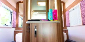 In-the-centre-of-the-preening-room,-a-dressing-table-with-a-backlit-mirror-43846