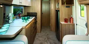 At-the-ed-of-the-kitchen-two-doors,-one-hinged,-the-other-sliding,-section-off-the-washing-facilities-41744