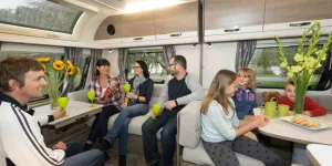 Two-familes,-seven-people-and-a-teddy-bear-in-two-seating-areas-31130