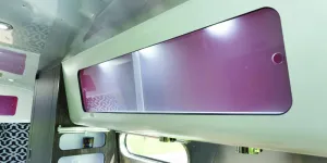 Frosted-sliding-doors-on-all-cabinets,-and-red-interiors,-are-all-part-of-the-Airstream-style-w800-71236