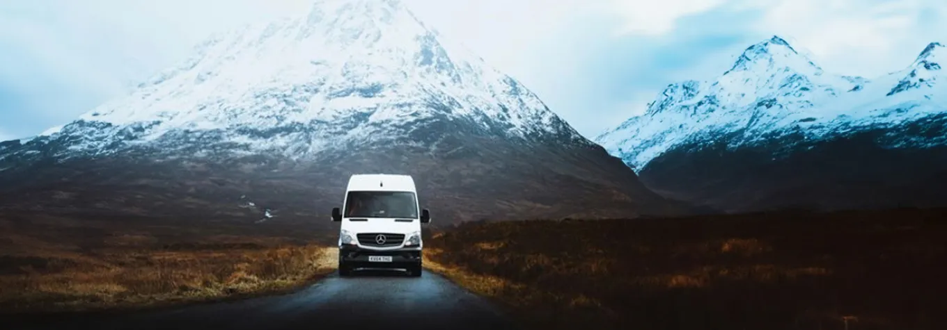 A campervan in the snowy mountains