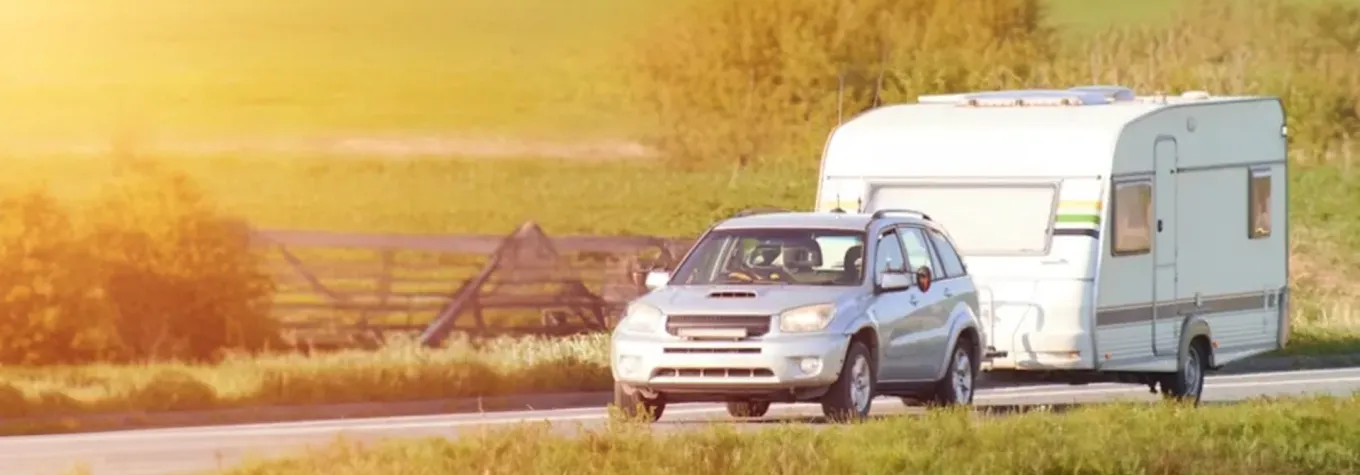 A caravan being towed in the countryside