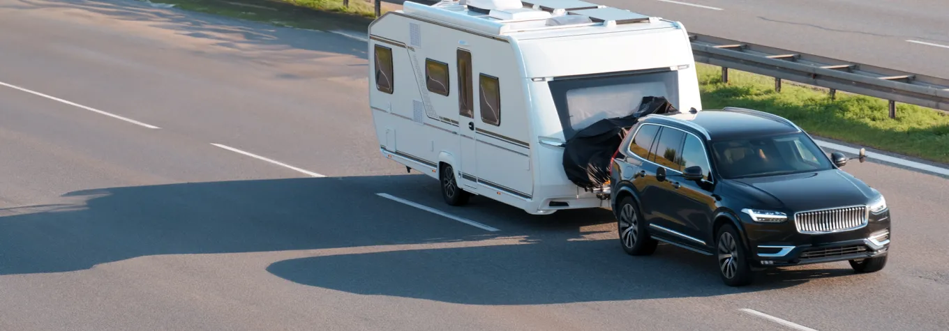 SUV Towing Large Home Trailer on Highway for Road Trip