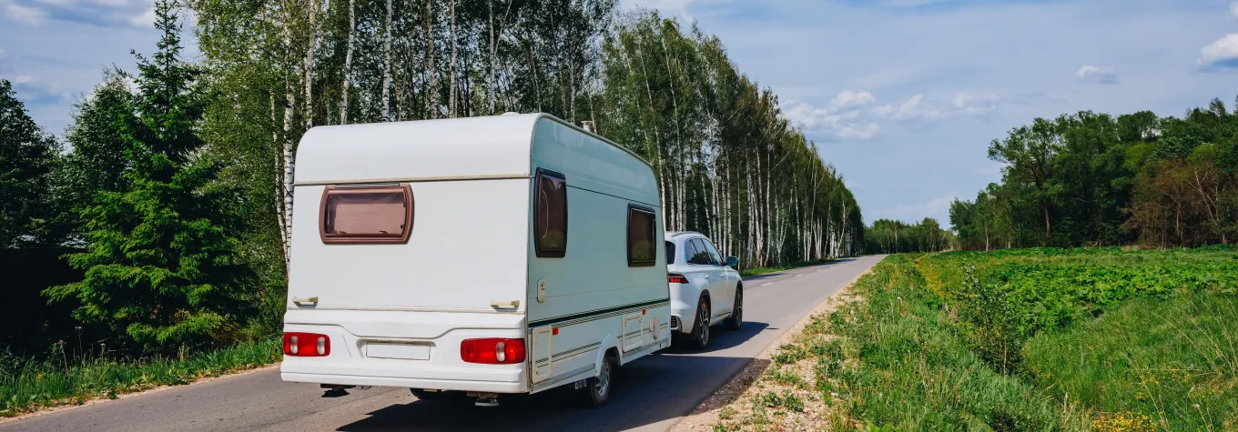 Caravan being towed to campsite on family holiday
