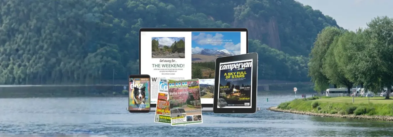 print and digital versions of motorhome, campervan, caravan and dog magazines displayed on a phone, tablet and laptop against a scenic countryside lake background