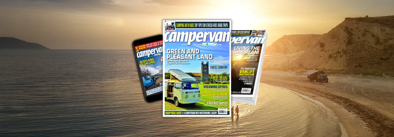 Campervan magazines stacked over a scenic road trip landscape.