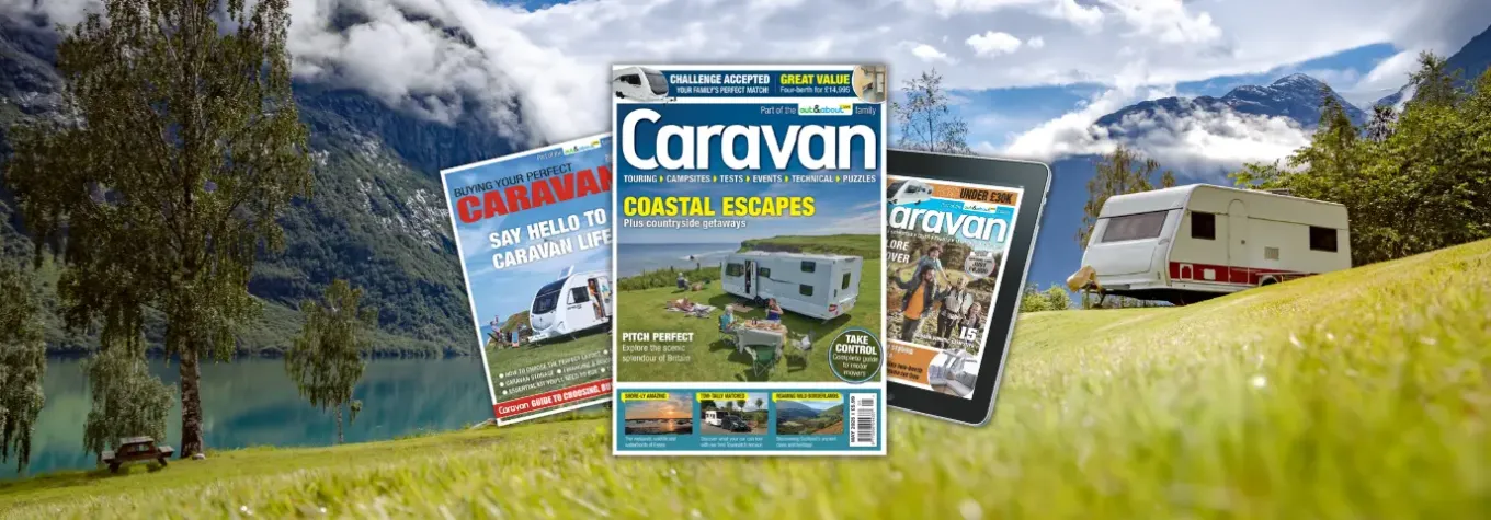 Caravan magazines stacked over a scenic road trip landscape.