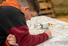 Enjoying the doodle boards in the beach barn at Campervan Campout Festival