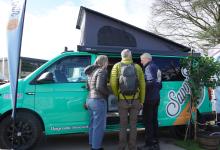A dealer showing potential buyers around a campervan at the Yorkshire Show