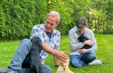 Robson Green sitting on a UK campsite with puppies