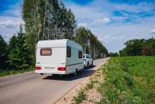Caravan being towed to campsite on family holiday