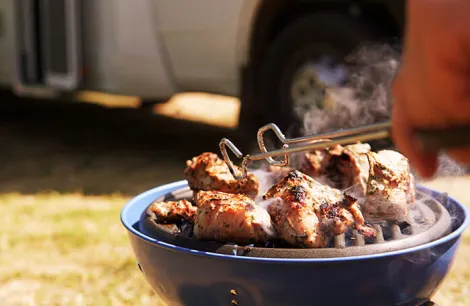 Gas barbecue on a pitch next to a motorhome