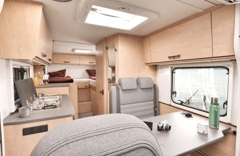 Sunlight Van V66 interior showing lounge, side kitchen and fixed single beds