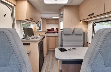 Sunlight V69 interior showing lounge, side kitchen and island bed at the rear