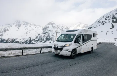 Sunlight Van Adventure V66 on snowy mountain roads