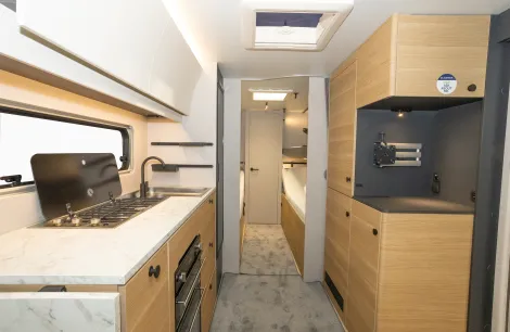 Beyond the kitchen, twin beds and the shower room at the rear