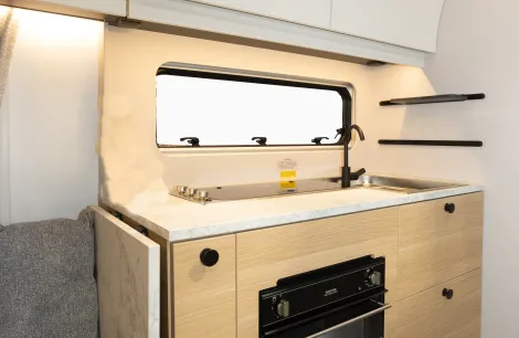 A hinged extension is on the fore end of the kitchen surface