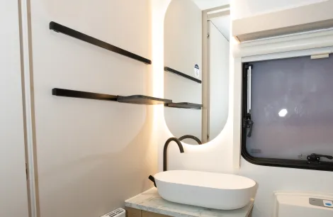 Rails that support small, clip-on shelves are in the washroom