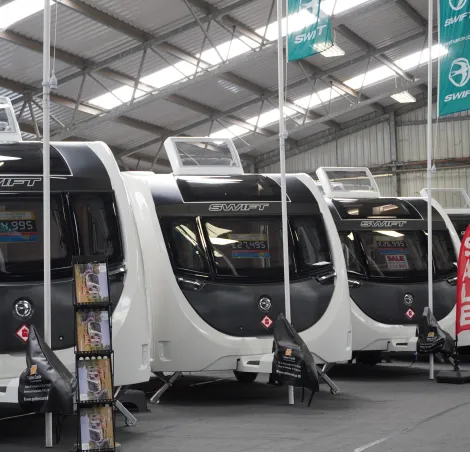 A selection of Caravans for sale inside one of halls at the Autumn show. There are traders indoors and outdoors at this show.