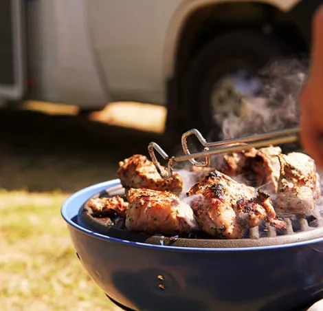 Gas barbecue on a pitch next to a motorhome