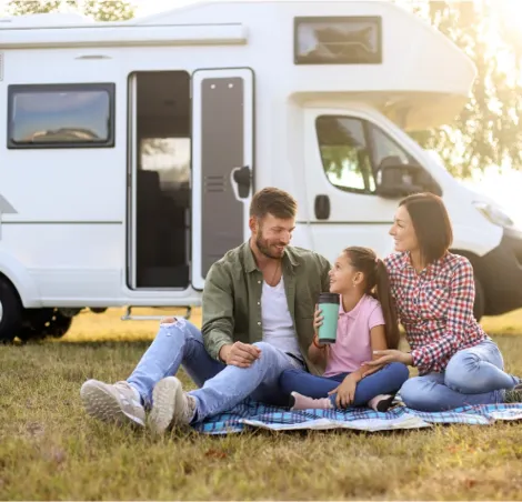 A family outside a motorhome